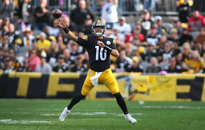 Mitch Trubisky throws the football in a wide leg stance